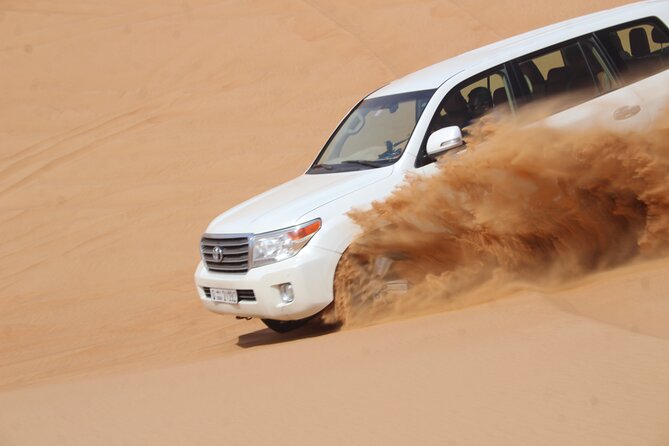 Dubai: Jeep Desert Safari, Camel Ride, and Quad Bike Tour - Al Aweer Camp BBQ and traditional entertainment: where the day cools off